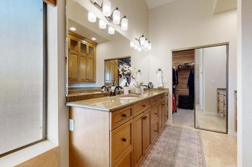 a kitchen with a sink and a mirror at Sun-Kissed in Scottsdale in Phoenix