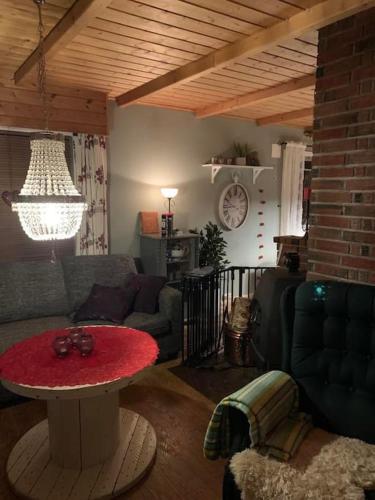 a living room with a couch and a table at Aurora House Dåfjord/Tromsø in Karlsøy
