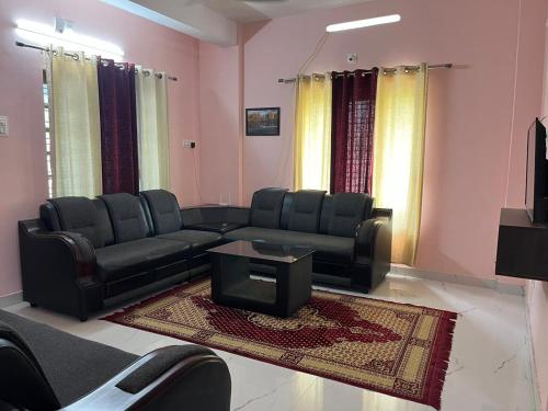 a living room with a couch and a table at Raha homes in Trivandrum