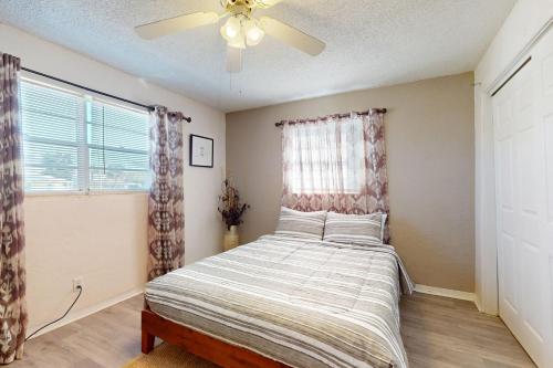 a bedroom with a bed and a ceiling fan at Seaside Escape in Ormond Beach