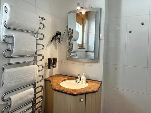 a bathroom with a sink and a mirror and towels at Maisonette - 45m2 zum Relaxen, mit Garage - ME17-B in Pontresina
