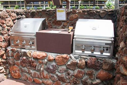 a stone wall with twourgers and a stove at Kepuhi Beach Resort in Maunaloa