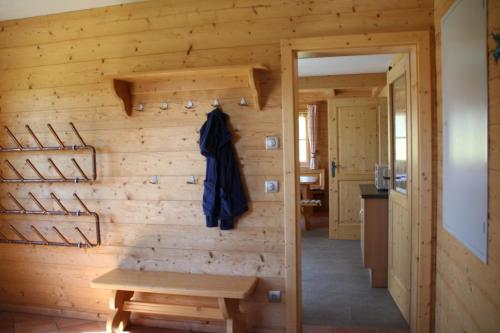 a room with a wooden wall with a wooden table at kleine Winklerhütte in Tauplitz