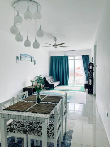 a white living room with a table and a couch at Putrajaya Homestay (Zurinn 2) in Putrajaya