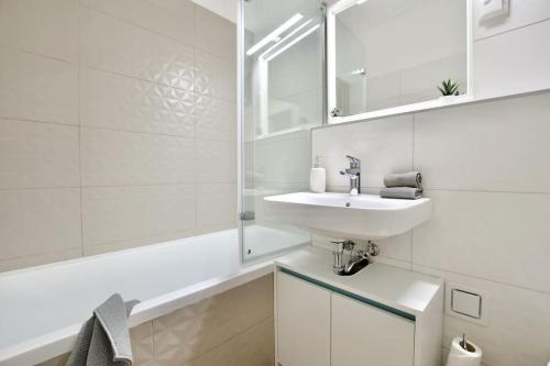 a white bathroom with a sink and a mirror at Standard Apartment by Hi5-Horváth Mihály square in Budapest