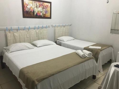 Ein Bett oder Betten in einem Zimmer der Unterkunft Rochas pousada
