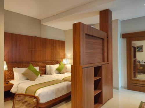a bedroom with a bed and a book shelf at Wyndham Garden Yogyakarta Hotel Conference & Action Park in Sleman