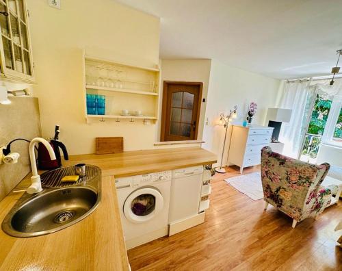 a kitchen with a sink and a washing machine at 300m od Rynku Sinus Apartaments in Wejherowo