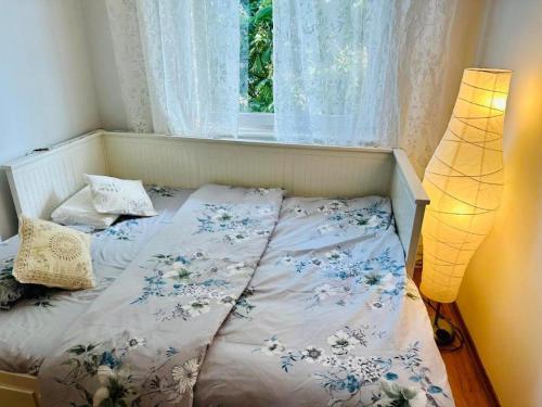 a bed in a room with a window at 300m od Rynku Sinus Apartaments in Wejherowo