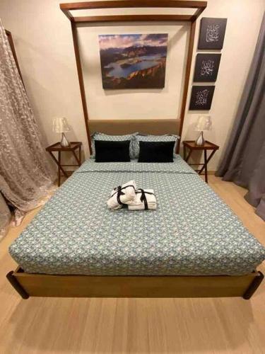 a bedroom with a bed with shoes on it at TimurBay Seafront ZarZyra Suite in Kuantan