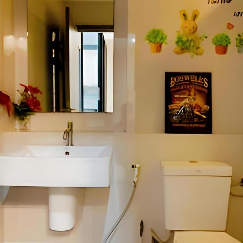 a bathroom with a sink and a toilet at THE BASE apartments at central pattaya in Pattaya