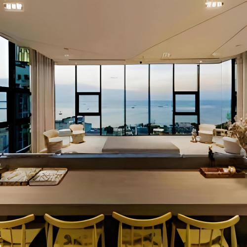 a room with a view of a living room with chairs at THE BASE apartments at central pattaya in Pattaya