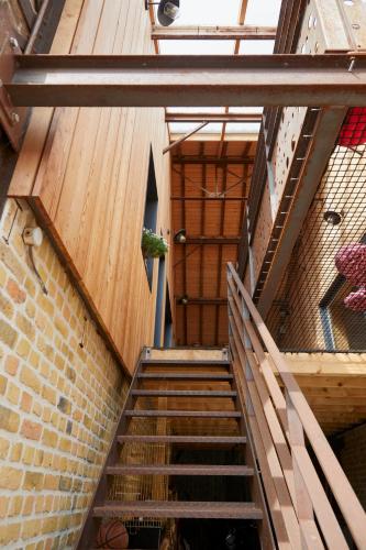a set of stairs leading up to a wooden door at Superbe grange réaménagée in Fampoux