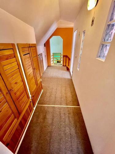 an empty hallway of a home with wooden doors at Casa Stana in Cavnic