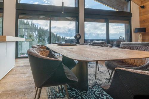 a dining room with a large table and chairs at Black Summit Boutique Resort Laax in Laax