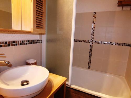 une salle de bain avec un lavabo et une baignoire dans l'établissement Charmant 4 pièces avec balcon, proche commerces et remontées, Alpe d'Huez, 6 pers, animaux acceptés - FR-1-405-133, à L'Alpe-d'Huez