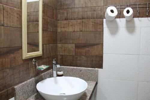 a bathroom with a white sink and a mirror at AP 20- Apart OH in Ciudad del Este