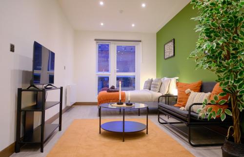 a living room with a couch and a table at GoldersGreen Apartments by Sleepy in London
