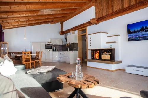 a living room with a couch and a fireplace at Der Pfindlhof in Leogang