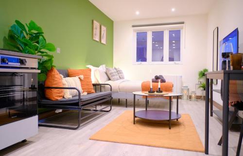 a living room with a couch and a table at GoldersGreen Apartments by Sleepy in London