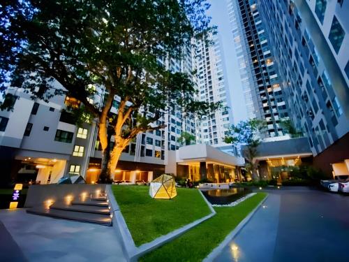 a park in the middle of a city at night at THE BASE apartments at central pattaya in Pattaya