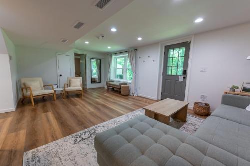 a living room with a couch and a table at Newly-renovated 5BR home near UVA, Downtown, i64 in Charlottesville