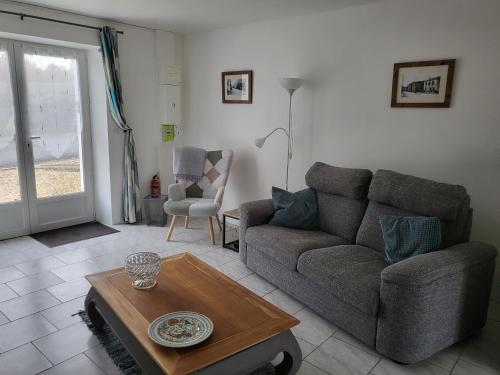 a living room with a couch and a coffee table at La Retraite Parfaite in Loubès-Bernac