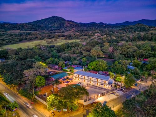 an aerial view of a building with a pool at Muna Santa Rosa Apartamentos in Tamarindo