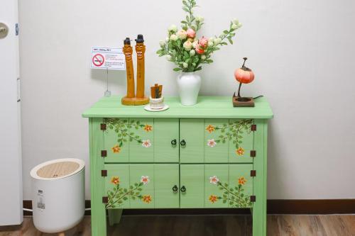 un meuble vert avec des fleurs au-dessus dans l'établissement JB Stay#Hongdae & Sinchon 10min#Double Room, à Séoul