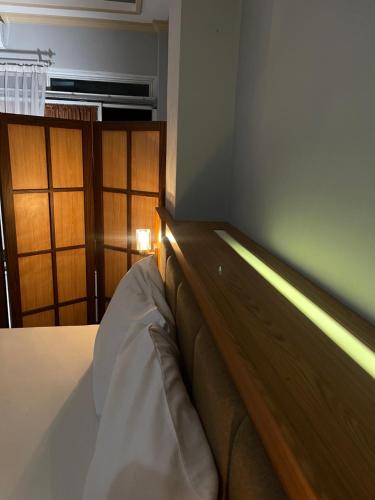 a bedroom with a bed with a wooden head board at Wesbobo inn Solo in Solo