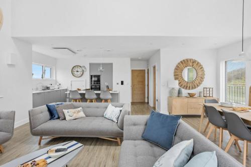 a living room with a couch and a table at 7 The Vista - Hot Tub - Pet Friendly in Woolacombe