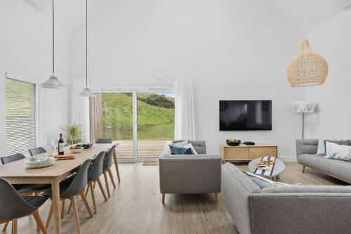 a living room with a couch and a table at 7 The Vista - Hot Tub - Pet Friendly in Woolacombe