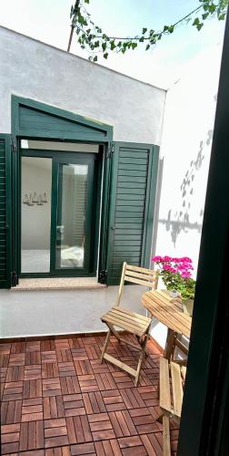 a patio with a chair and a table and a mirror at Appartamento vicino spiaggia in Portoscuso