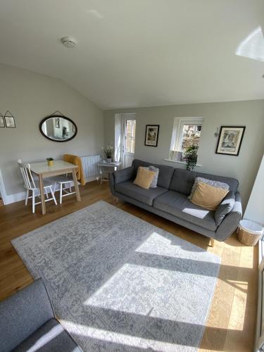 a living room with a couch and a table at The Hill B&B in Middleton in Teesdale