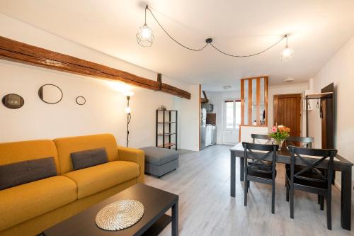 a living room with a couch and a table at Les Logis de Marcoussis in Marcoussis