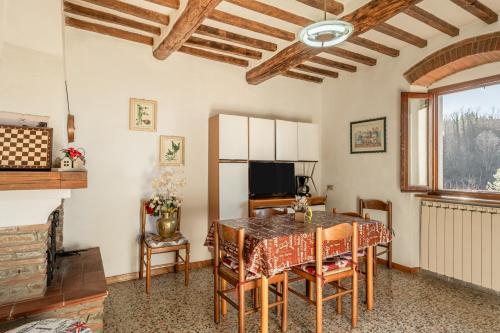 a dining room with a table and chairs and a television at Casa Claire in Prataccio