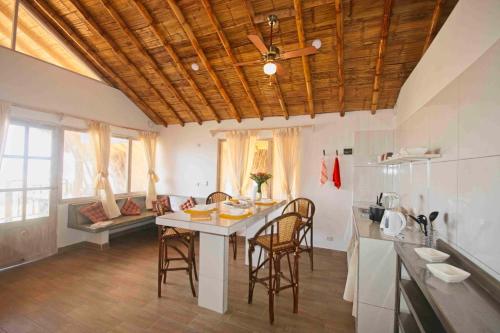 a kitchen with a table and chairs in a room at Modern Appartments with private beach in Máncora