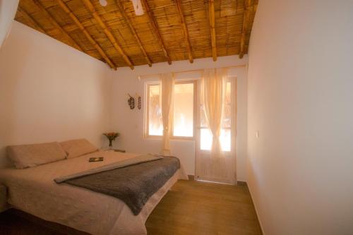 a bedroom with a bed and a large window at Modern Appartments with private beach in Máncora