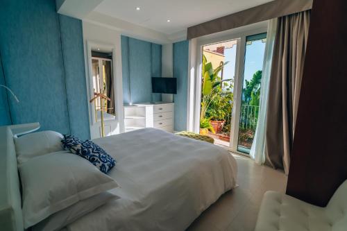 a bedroom with a large bed and a balcony at Taormina Sunrise in Taormina