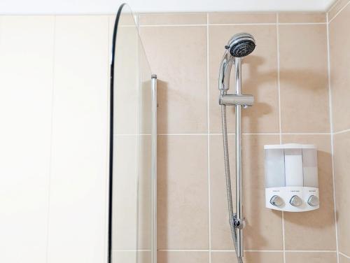 a shower with a shower head in a bathroom at Red Oak - Bosham in Bosham
