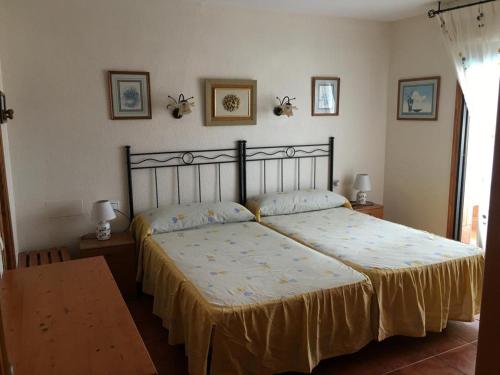 a bedroom with a bed and two lamps and a table at Roquemar dreams 523 in Roquetas de Mar