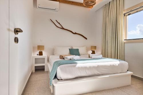 a bedroom with a bed with two stuffed animals on it at Villa Manikas Milos in Adamas