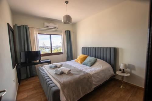 a bedroom with a bed with towels on it at Glabur Stays! The One -1 - Elite Marina Front! in Zygi