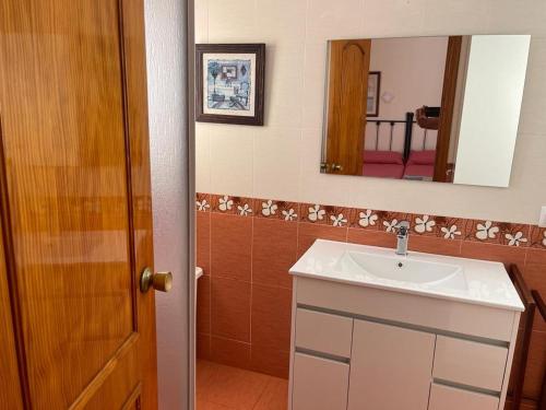 a bathroom with a sink and a mirror at Roquemar dreams 435 in Roquetas de Mar