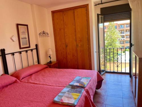 a bedroom with a bed and a sliding glass door at Roquemar dreams 435 in Roquetas de Mar