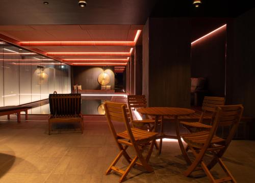 a restaurant with wooden tables and chairs and lights at Bergstadens Hotel & Spa in Røros