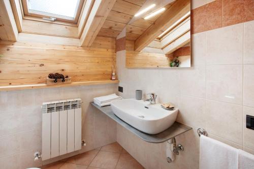 a bathroom with a sink and a mirror at Chalet Primula 13 in Santa Caterina Valfurva