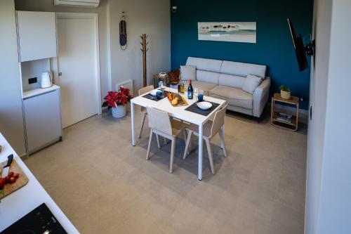 a kitchen and living room with a table and a couch at Virdamuri - Etna Country Resort in Giarre
