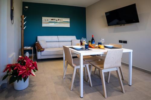 a living room with a white table and chairs at Virdamuri - Etna Country Resort in Giarre