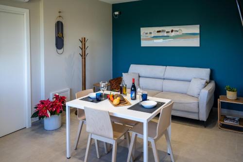 a living room with a white table and a couch at Virdamuri - Etna Country Resort in Giarre